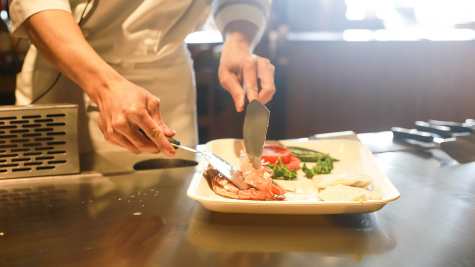 A chef putting food on a plate