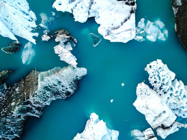 Aerial view of amazing glacier patterns and shapes in Jokulsarlon lake, Iceland. Glacial lagoon with icebergs floating. Climate change, global warming, melting glacier.