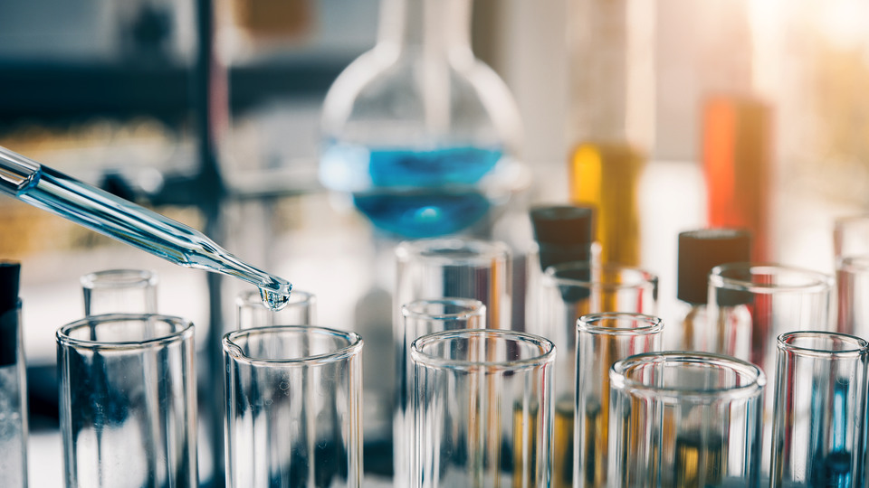 Chemicals are dropped into containers using a pipette
