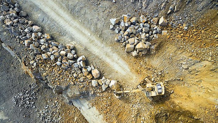 Aerial view of a excavator in the mine.  Industrial background from landscape after mining.